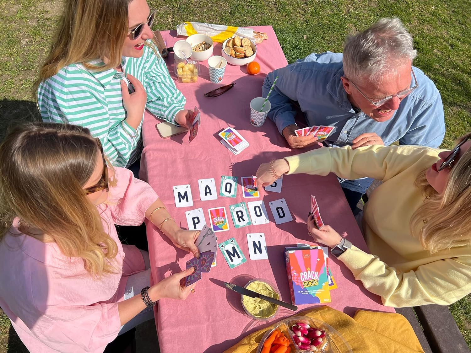 Friends playing Crack Story at a picnic
